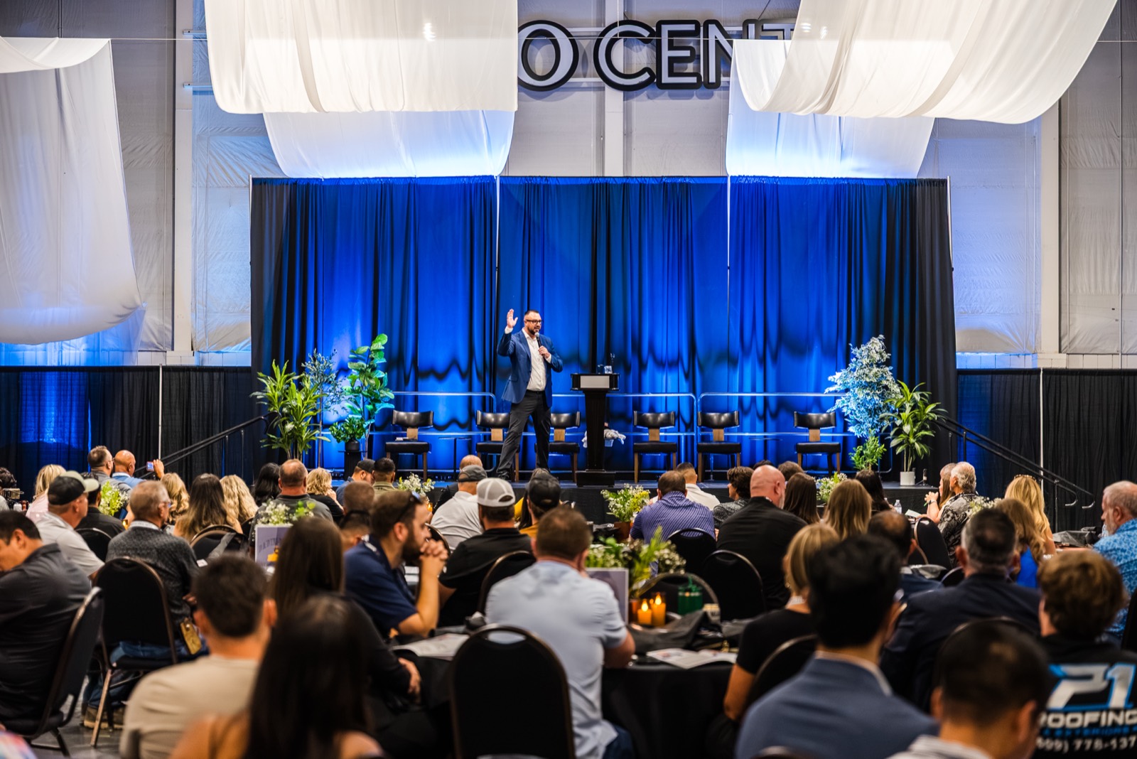 Adam Diaz speaking on stage to a full room at the Eastern Washington Real Estate Summit